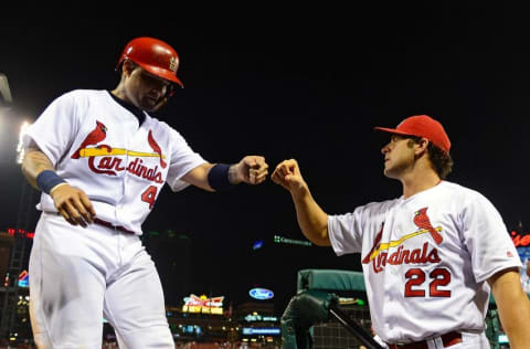 Aug 24, 2016; St. Louis, MO, USA; St. Louis Cardinals catcher Yadier Molina (4) is congratulated by manager 