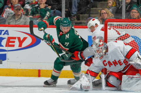 SAINT PAUL, MN – NOVEMBER 16: Lucas Wallmark #71 and James Reimer #47 of the Carolina Hurricanes defend their goal against Zach Parise #11 of the Minnesota Wild during the game at the Xcel Energy Center on November 16, 2019 in Saint Paul, Minnesota. (Photo by Bruce Kluckhohn/NHLI via Getty Images)