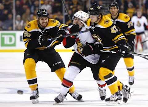 Dec 29, 2015; Boston, MA, USA; Ottawa Senators center Jean-Gabriel Pageau (44) gets hit between Boston Bruins center Zac Rinaldo (36) and defenseman Torey Krug (47) during the first period at TD Garden. The Bruins won 7-3. Mandatory Credit: Winslow Townson-USA TODAY Sports