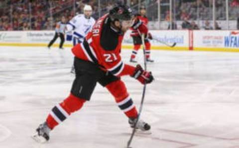 Feb 26, 2016; Newark, NJ, USA; New Jersey Devils right wing Kyle Palmieri (21) shoots the puck during the second period of their game against the Tampa Bay Lightning at Prudential Center. Mandatory Credit: Ed Mulholland-USA TODAY Sports