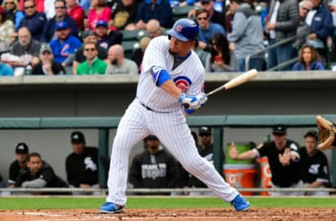 Feb 27, 2017; Mesa, AZ, USA; Chicago Cubs catcher Kyle Schwarber (12) singles during the first inning against the Chicago White Sox during a spring training game at Sloan Park. Mandatory Credit: Matt Kartozian-USA TODAY Sports. MLB.