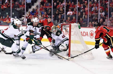 Dec 2, 2016; Calgary, Alberta, CAN; Calgary Flames center Mikael Backlund (11) tries to score on Minnesota Wild goalie Devan Dubnyk (40) during the third period at Scotiabank Saddledome. The Flames won 3-2 in a shootout. Mandatory Credit: Candice Ward-USA TODAY Sports