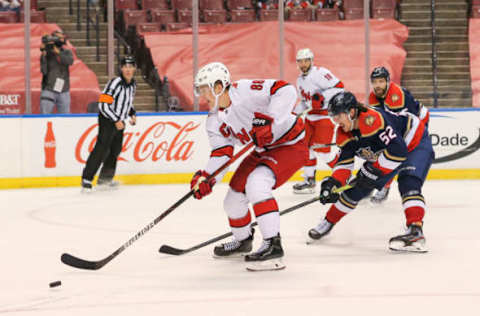 Feb 27, 2021; Sunrise, Florida, USA; Carolina Hurricanes center Martin Necas (88) skates with the puck around Florida Panthers defenseman MacKenzie Weegar (52) during the third period at BB&T Center. Mandatory Credit: Sam Navarro-USA TODAY Sports