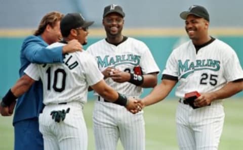 Florida Marlins 1997 World Series players, from left, Darren Daulton, Gary Sheffield, Charles Johnson and Bobby Bonilla congratulate each other after receiving their World Series championship rings during a ceremony held 05 April at Pro Player Stadium in Miami, Florida. Within a short time none were still with the team.  AFP PHOTO/Rhona WISE (Photo credit should read RHONA WISE/AFP/Getty Images)