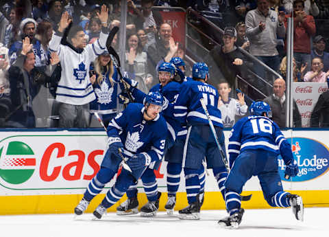 TORONTO, ON – DECEMBER 23: Mitch Marner #16 of the Toronto Maple Leafs celebrates his goal against the Carolina Hurricanes with teammates Auston Matthews #34, Justin Holl #3, Zach Hyman #11 and Jake Muzzin #8 during the third period at the Scotiabank Arena on December 23, 2019 in Toronto, Ontario, Canada. (Photo by Mark Blinch/NHLI via Getty Images)