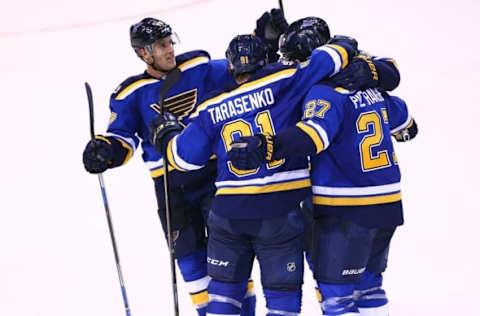 Nov 9, 2016; St. Louis, MO, USA; St. Louis Blues defenseman Alex Pietrangelo (27) is congratulated by teammates Vladimir Tarasenko (91) and Jaden Schwartz (17) after scoring a goal against the Chicago Blackhawks during the third period at Scottrade Center. The Blackhawks won 2-1 in overtime. Mandatory Credit: Billy Hurst-USA TODAY Sports