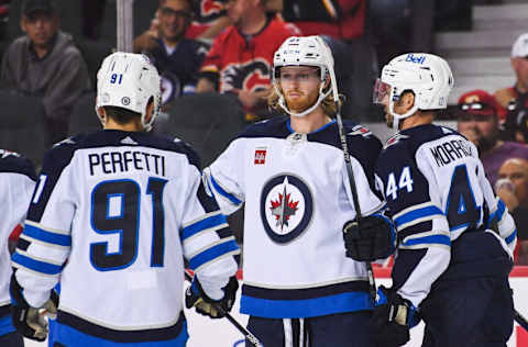 CALGARY, CANADA - OCTOBER 7: Kyle Connor #81 (C) of the Winnipeg Jets celebrates with his teammates after scoring against the Calgary Flames during an NHL game at Scotiabank Saddledome on October 7, 2022 in Calgary, Alberta, Canada. (Photo by Derek Leung/Getty Images)