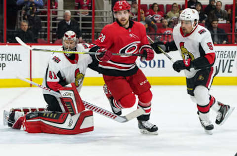 RALEIGH, NC – MARCH 26: Carolina Hurricanes Center Elias Lindholm (28) skates after a puck in front of Ottawa Senators Defenceman Cody Ceci (5) and Ottawa Senators Goalie Craig Anderson (41) during a game between the Ottawa Senators and the Carolina Hurricanes at the PNC Arena in Raleigh, NC on March 24, 2018. Carolina defeated Ottawa 4-1. (Photo by Greg Thompson/Icon Sportswire via Getty Images)