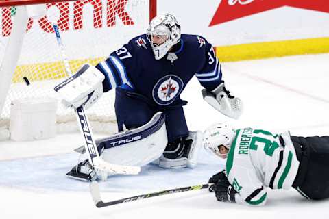 Dallas Stars, Jason Robertson (21); Winnipeg Jets, Connor Hellebuyck (37). Mandatory Credit: James Carey Lauder-USA TODAY Sports