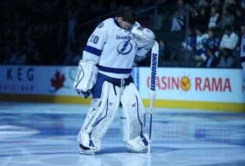 Mar 19, 2014; Toronto, Ontario, CAN; Tampa Bay Lightning goalie Ben Bishop (30) stands for the playing of the anthems before the start of their game against the Toronto Maple Leafs at Air Canada Centre. The Lightning beat the Maple Leafs 5-3. Mandatory Credit: Tom Szczerbowski-USA TODAY Sports