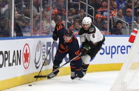 EDMONTON, CANADA – DECEMBER 7: Connor McDavid #97 of the Edmonton Oilers tries to get away from Jakob Chychrun #6 of the Arizona Coyotes. (Photo by Lawrence Scott/Getty Images)