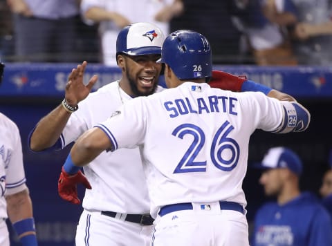 TORONTO, ON – JUNE 15: Yangervis Solarte #26 of the Toronto Blue Jays is congratulated by Teoscar Hernandez #37 after hitting a two-run home run in the seventh inning during MLB game action against the Washington Nationals at Rogers Centre on June 15, 2018 in Toronto, Canada. (Photo by Tom Szczerbowski/Getty Images)