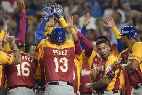 Salvador Perez of Venezuela celebrates with teammates after hitting a home run in the second inning against Puerto Rico. (Photo by Eric Espada/Getty Images)