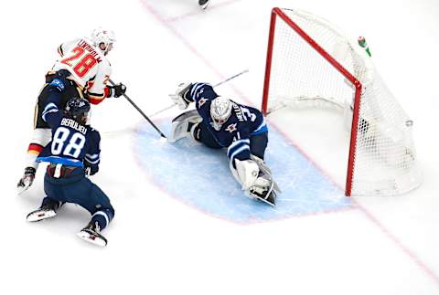 Nathan Beaulieu #88 and Connor Hellebuyck #37 of the Winnipeg Jets. (Photo by Jeff Vinnick/Getty Images)