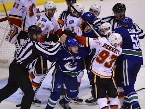 Oct 15, 2016; Vancouver, British Columbia, CAN; Vancouver Canucks forward Derek Dorsett (15) and Calgary Flames forward Sam Bennett (93) fight in front of the Calgary Flames goal during the third period at Rogers Arena. The Vancouver Canucks won 2-1 in a shootout. Mandatory Credit: Anne-Marie Sorvin-USA TODAY Sports