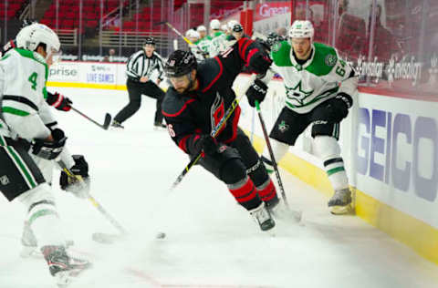 Jan 30, 2021; Raleigh, North Carolina, USA; Carolina Hurricanes center Vincent Trocheck (16) battles for the puck against Dallas Stars center Tanner Kero (64) during the third period at PNC Arena. Mandatory Credit: James Guillory-USA TODAY Sports