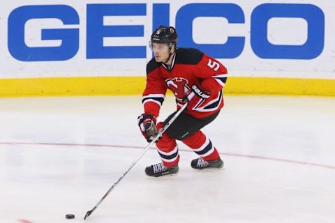 Jan 19, 2016; Newark, NJ, USA; New Jersey Devils defenseman Adam Larsson (5) skates with the puck during the third period at Prudential Center. The Devils won 4-2. Mandatory Credit: Ed Mulholland-USA TODAY Sports