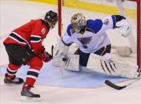 Jan 21, 2014; Newark, NJ, USA; St. Louis Blues goalie Jaroslav Halak (41) makes a save on New Jersey Devils right wing Dainius Zubrus (8) during the third period at the Prudential Center. The Devils won 7-1. Mandatory Credit: Ed Mulholland-USA TODAY Sports