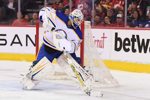 Mar 18, 2022; Calgary, Alberta, CAN; Buffalo Sabres goalie Dustin Tokarski (31) stops a puck against the Calgary Flames during the first period at Scotiabank Saddledome. Mandatory Credit: Candice Ward-USA TODAY Sports