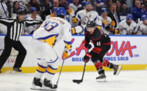 Feb 1, 2023; Buffalo, New York, USA; Carolina Hurricanes left wing Jordan Martinook (48) carries the puck up ice as Buffalo Sabres defenseman Mattias Samuelsson (23) defends during the third period at KeyBank Center. Mandatory Credit: Timothy T. Ludwig-USA TODAY Sports