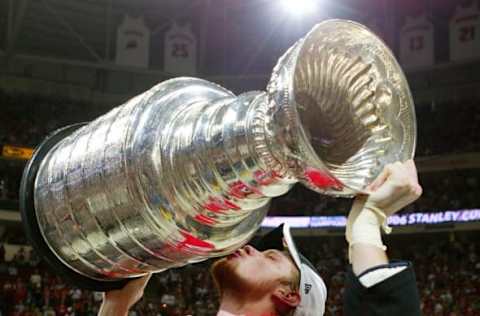 RALEIGH, NC – JUNE 19: Eric Staal #12 of the Carolina Hurricanes kisses the Stanley Cup after defeating the Edmonton Oilers in game seven of the 2006 NHL Stanley Cup Finals on June 19, 2006 at the RBC Center in Raleigh, North Carolina. The Hurricanes defeated the Oilers 3-1 to win the Stanley Cup finals 4 games to 3. (Photo by Jim McIsaac/Getty Images)