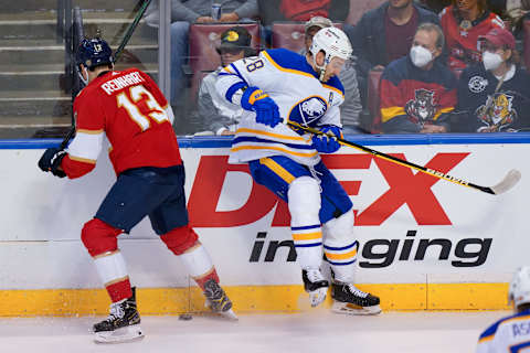 Dec 2, 2021; Sunrise, Florida, USA; Florida Panthers center Sam Reinhart (13) checks Buffalo Sabres center Zemgus Girgensons (28) off the puck during the first period at FLA Live Arena. Mandatory Credit: Jasen Vinlove-USA TODAY Sports