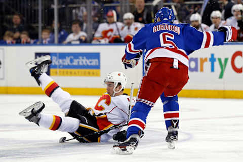 Feb 5, 2017; New York, NY, USA; New York Rangers defenseman Dan Girardi (5) is called for tripping on Calgary Flames left wing Micheal Ferland (79) during the first period at Madison Square Garden. Mandatory Credit: Adam Hunger-USA TODAY Sports.