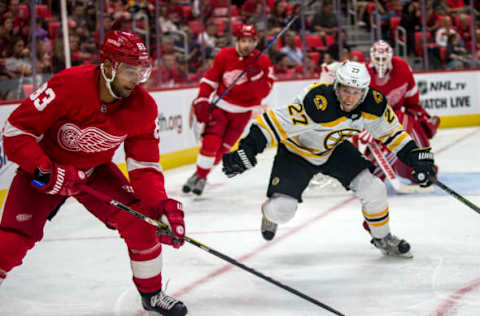 DETROIT, MI – SEPTEMBER 23: Detroit Red Wings defenseman Trevor Daley (83) handles the puck, challenged by Boston Bruins forward Austin Czarnik (27), in the third period of the Boston Bruins at Detroit Red Wings pre-season NHL hockey game on September 23, 2017 at Little Caesars Arena, in Detroit, MI. The Red Wings won 5-1. (Photo by Tony Ding/Icon Sportswire via Getty Images)