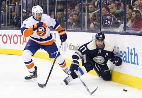 Dec 12, 2015; Columbus, OH, USA; New York Islanders defenseman Travis Hamonic (3) battles Columbus Blue Jackets center Brandon Dubinsky (17) for the puck at Nationwide Arena. The Islanders won 3-2 in overtime. Mandatory Credit: Aaron Doster-USA TODAY Sports