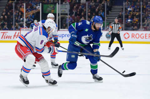 VANCOUVER, CANADA – FEBRUARY 15: Phillip Di Giuseppe #34 of the Vancouver Canucks skates with the puck as Jacob Trouba #8 of the New York Rangers defends during the second period of their NHL game at Rogers Arena on February 15, 2023, in Vancouver, British Columbia, Canada. (Photo by Derek Cain/Getty Images)