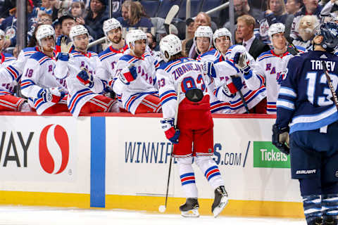 WINNIPEG, MB – FEBRUARY 12: Mika Zibanejad #93 of the New York Rangers celebrates his third period goal against the Winnipeg Jets with teammates at the bench at the Bell MTS Place on February 12, 2019 in Winnipeg, Manitoba, Canada. (Photo by Jonathan Kozub/NHLI via Getty Images)