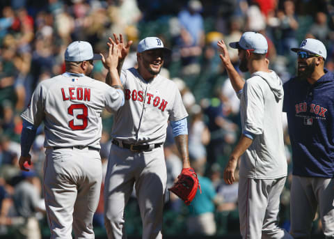 SEATTLE, WA – JUNE 17: Hector Velazquez #76 of the Boston Red Sox gets a high five from Sandy Leon #3 after closing out the game against the Seattle Mariners at Safeco Field on June 17, 2018 in Seattle, Washington. The Boston Red Sox beat the Seattle Mariners 9-3. (Photo by Lindsey Wasson/Getty Images)