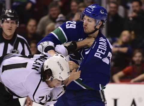 Dec 28, 2015; Vancouver, British Columbia, CAN; Los Angeles Kings forward Jordan Nolan (71) and Vancouver Canucks defenseman Andrey Pedan (29) fight during the first period at Rogers Arena. Mandatory Credit: Anne-Marie Sorvin-USA TODAY Sports