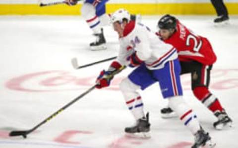 Mar 19, 2016; Ottawa, Ontario, CAN; Montreal Canadiens right wing Michael McCarron (34) plays the puck against Ottawa Senators left wing Matt Puempel (26) during the first period at Canadian Tire Centre. Mandatory Credit: Jean-Yves Ahern-USA TODAY Sports