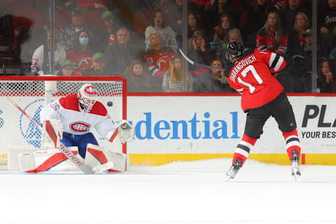 Yegor Sharangovich scores on Sam Montembeault during a shootout. (Photo by Rich Graessle/Getty Images)