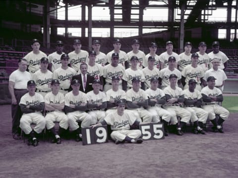 BROOKLYN, NY – SEPTEMBER 16, 1955: Members of the Brooklyn Dodgers poses for a portrait prior to a game on September 16, 1955 at Ebbets Field in Brooklyn, New York. Pictured are: Front row, (L to R): George Shuba, Don Zimmer, Joe Becker, Jake Pitler (Coach), Walt Alston (Manager), Billy Herman (Coach), Pee Wee Reese, Dixie Howell, Sandy Amoros and Roy Campanella. Second row, (L to R): John Griffin (club houseman), Carl Erskine, Sandy Koufax, Lee Scott (Road Secretary), Roger Craig, Don Newcombe, Karl Spooner, Don Hoak, Carl Furillo, Frank Kellert and Doc Wendler (trainer). Third row, (L to R): Russ Meyer, Jim Gilliam, Billy Loes, Clem Labine, Gil Hodges, Ed Roebuck, Don Bessent, Duke Snider, John Podres, Al Rube Walker and Jackie Robinson. Batboy Charlie Digiovanni is in front. (Photo by: Kidwiler Collection/Diamond Images/Getty Images)