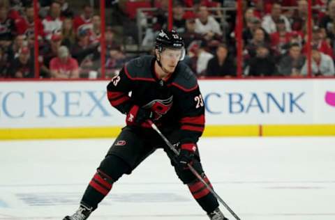 RALEIGH, NC – MAY 16: Brock McGinn #23 of the Carolina Hurricanes controls the puck on the ice in Game Four of the Eastern Conference Third Round against the Boston Bruins during the 2019 NHL Stanley Cup Playoffs on May 16, 2019 at PNC Arena in Raleigh, North Carolina. (Photo by Gregg Forwerck/NHLI via Getty Images)