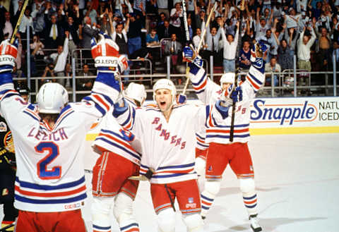 Sergei Zubov #21, Brian Leetch #2 and Mark Messier #11 of the New York Rangers celebrate (Photo by J Giamundo/Bruce Bennett Studios/Getty Images)