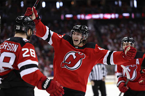 NEWARK, NEW JERSEY – MAY 07: Damon Severson #28 of the New Jersey Devils celebrates his goal with teammates Luke Hughes #43 and Jack Hughes #86 during the second period in Game Three of the Second Round of the 2023 Stanley Cup Playoffs against the Carolina Hurricanes at Prudential Center on May 07, 2023 in Newark, New Jersey. both Hughes recorded an assist on the goal. (Photo by Elsa/Getty Images)