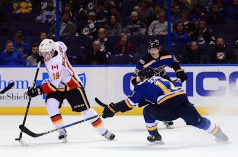 Oct 25, 2016; St. Louis, MO, USA; Calgary Flames left wing Matthew Tkachuk (19) handles the puck as St. Louis Blues left wing Jaden Schwartz (17) defends during the first period at Scottrade Center. Mandatory Credit: Jeff Curry-USA TODAY Sports