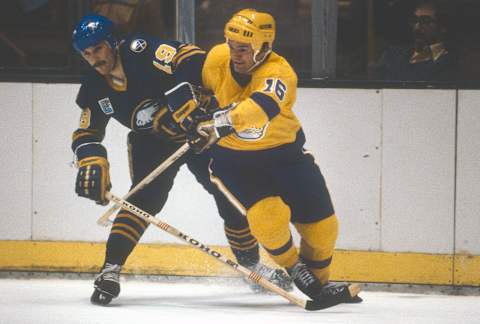 LOS ANGELES, CA- CIRCA 1981: Marcel Dionne #16 of the Los Angeles Kings collides with Derek Smith #19 of the Buffalo Sabers during an NHL Hockey game circa 1981 at the Great Western Forum in Los Angeles, California. Dionne’s playing career went from 1971-89. (Photo by Focus on Sport/Getty Images)