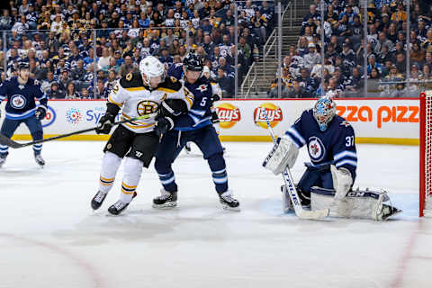 WINNIPEG, MB – MARCH 14: David Backes #42 of the Boston Bruins and Dmitry Kulikov #5 of the Winnipeg Jets watch as goaltender Connor Hellebuyck #37 makes a first period save at the Bell MTS Place on March 14, 2019 in Winnipeg, Manitoba, Canada. The Jets defeated the Bruins 4-3. (Photo by Jonathan Kozub/NHLI via Getty Images)