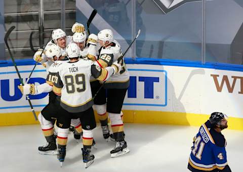 Zach Whitecloud #2 of the Vegas Golden Knights is congratulated by his teammates after scoring a goal against the St. Louis Blues during the Third period in a Western Conference Round Robin game. (Photo by Jeff Vinnick/Getty Images)