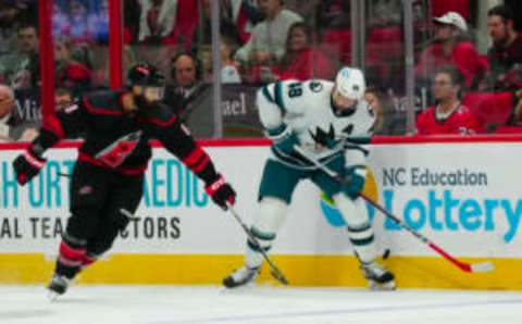 Oct 27, 2023; Raleigh, North Carolina, USA; Carolina Hurricanes defenseman Brent Burns (8) and San Jose Sharks center Tomas Hertl (48) battles over the puck during the second period at PNC Arena. Mandatory Credit: James Guillory-USA TODAY Sports