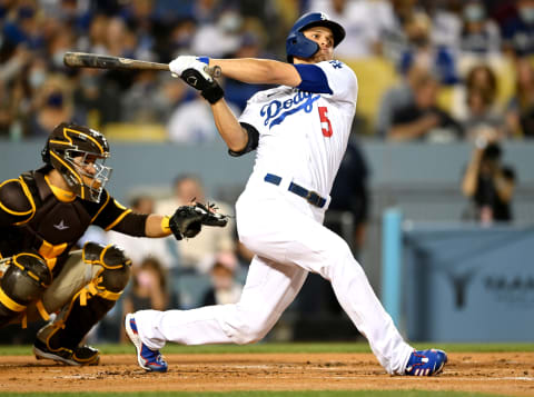 Sep 30, 2021; Los Angeles, California, USA; Los Angeles Dodgers shortstop Corey Seager (5) hits a solo home run in the first inning of the game against the San Diego Padres at Dodger Stadium. Mandatory Credit: Jayne Kamin-Oncea-USA TODAY Sports