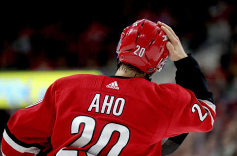 RALEIGH, NC – MARCH 21: Sebastian Aho #20 of the Carolina Hurricanes adjusts his helmet during an NHL game against the Tampa Bay Lightning on March 21, 2019 at PNC Arena in Raleigh, North Carolina. (Photo by Gregg Forwerck/NHLI via Getty Images)