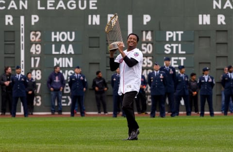 BOSTON, MA – OCTOBER 2: Former Red Sox pitcher Pedro Martinez raises the 2004 World Series championship trophy before David Ortiz’s last regular season game against the Toronto Blue Jays at Fenway Park on October 2, 2016 in Boston, Massachusetts. (Photo by Rich Gagnon/Getty Images)