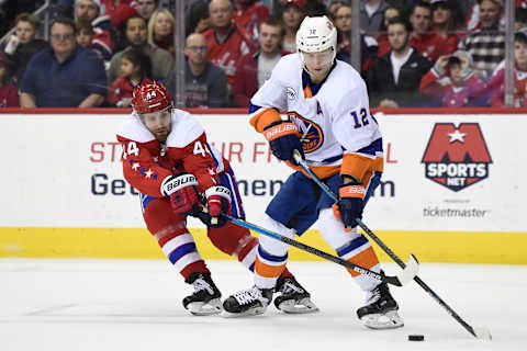 WASHINGTON, DC – JANUARY 18: Josh Bailey #12 of the New York Islanders and Brooks Orpik #44 of the Washington Capitals battle for the puck in the third period at Capital One Arena on January 18, 2019 in Washington, DC. (Photo by Patrick McDermott/NHLI via Getty Images)