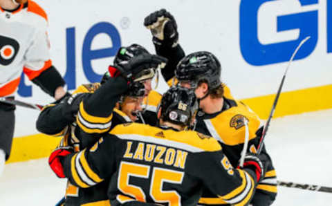 Jan 23, 2021; Boston, Massachusetts, USA; Boston Bruins center Craig Smith (12) celebrates with teammates after scoring a goal during the second period against the Philadelphia Flyers at TD Garden. Mandatory Credit: Paul Rutherford-USA TODAY Sports