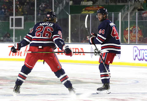 REGINA, SASKATCHEWAN – OCTOBER 26: Blake Wheeler #26 of the Winnipeg Jets celebrates teammate Josh Morrissey’s tying goal in the third period during the 2019 Tim Hortons NHL Heritage Classic between the Calgary Flames and the Winnipeg Jets at Mosaic Stadium on October 26, 2019 in Regina, Canada. The Jets defeated the Flames 2-1 in overtime. (Photo by Jonathan Kozub/NHLI via Getty Images)